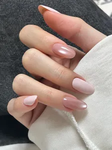 Close-up of elegant gradient pink press-on nails with shiny finish and oval shape