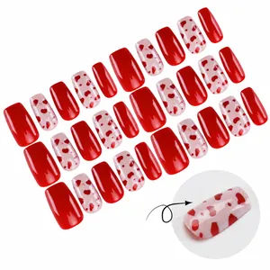 Short square press-on nails with red heart patterns and pink glitter for Valentine's Day