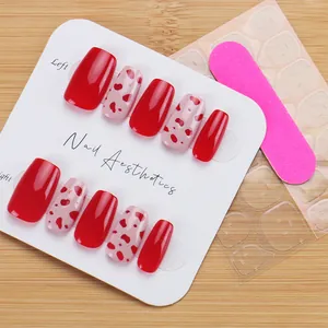 Detailed set of red and pink heart dotted press-on nails with glue and mini file
