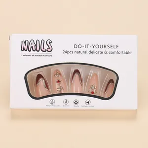 Detail of almond-shaped press-on nails set with red French tips and metallic lines
