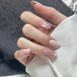 Elegant almond-shaped press-on nails with soft pink and nude gradient pearl finish