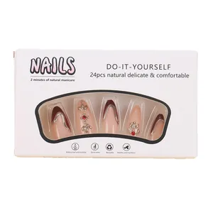 Medium almond press-on nails set in nude pink with red swirls and silver accents