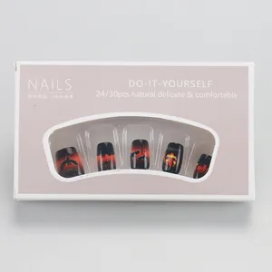 Detailed close-up of Halloween nail set with orange pumpkin and black bat designs
