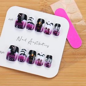 Detail of short square Halloween press-on nails with purple castle and bat motifs