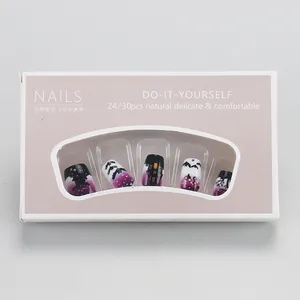 Detail of Halloween press-on nails set featuring purple black bat and castle patterns