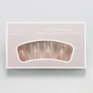 Détail de faux ongles amande à dégradé œil de chat rose dans leur boîte élégante