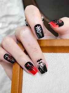 Detail of red and black rose bat press-on nails with shiny finish and blood drip design