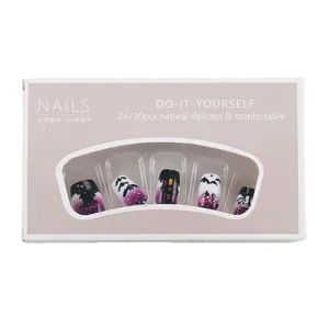 Short Halloween press-on nails with purple castle and bat designs in a window gift box