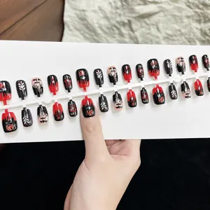 Detailed view of red and black rose bat press-on nails in various sizes with hand display