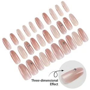 Medium oval press-on nails set in nude pink gradient with glitter and 3D rhinestones