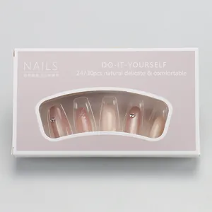 Detail of nude pink press-on nails with silver glitter and rhinestone accents on box