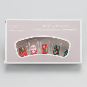 Vue détaillée de kit d'ongles de Noël avec motifs de Père Noël et flocons de neige