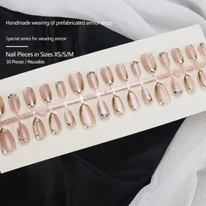 Short oval champagne cat eye press-on nails with French gold edges and rhinestones
