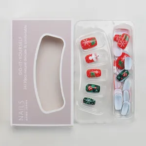 Faux ongles de Noël avec motifs Père Noël et flocons dans leur emballage de vente