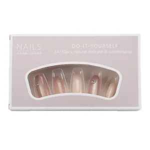 Pink gradient press-on nails with rhinestones and glitter in a professional package