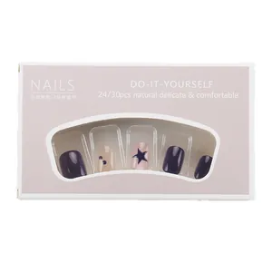 Short round dark purple glitter press-on nails with blue star design in a pink gift box