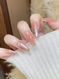 Detail of pink gradient trapezoid nails with pearls, rhinestones and cat eye effect