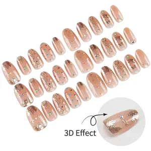 Short press-on nails with 3D star moon patterns and gradient pink rhinestone accents