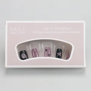 Short French style press-on nails in purple and black with stars and cat eye effect