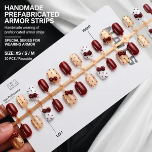 Short wine red press-on nails set with elegant bow designs and polka dot accents