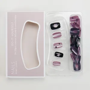 Detail of purple and black cat eye press-on nails with stars and gemstone accents