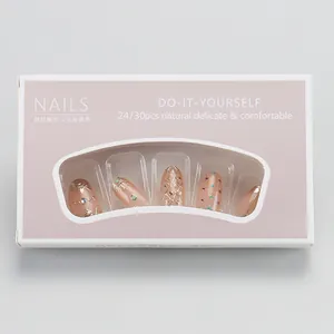 Detail of luxury star and moon press-on nails set in elegant window packaging