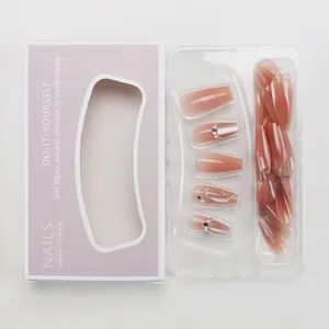 Detailed view of nude pink gradient press-on nails with pearls and diamond accents
