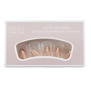 Press-on nails with galaxy star moon design in nude pink with gold accents and gems