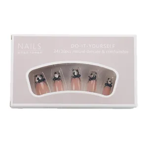 Pink and black bow tie press-on nails in medium trapezoid shape with heart accents