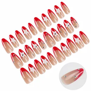 Detail of red French almond press-on nails with white stars and 3D rhinestone accents