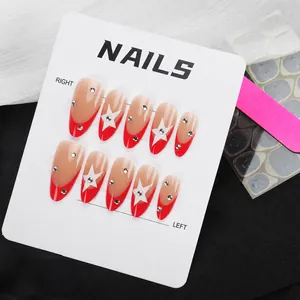 Detail of French red-tip press-on nails with white stars and rhinestones including tool kit