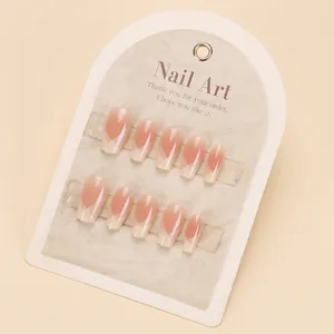 Macro detail of high-gloss pink and beige V-shape geometric gradient press-on nails