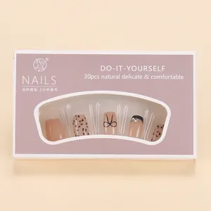 Detail of autumn press-on nails featuring cat-eye leopard print and rhinestone accents