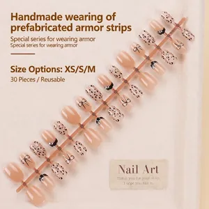 Press-on nail set with leopard print, black bows and rhinestones in nude and black