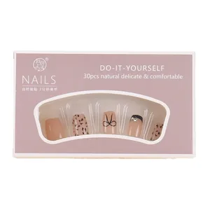 Press-on nail set with 30 pieces featuring leopard print, black bows, and rhinestones