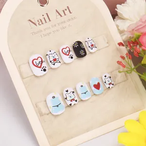 Detailed view of kids' press-on nails featuring cute bear, heart, and flower patterns