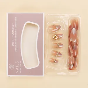 Press-on nail set featuring 30 pink gradient pieces with gold glitter and rhinestones