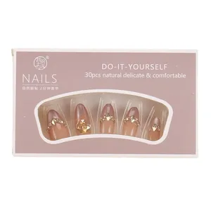 Cat eye press-on nail kit with pink gradient and rhinestones in window gift box
