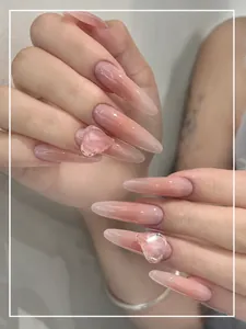 Macro view of long stiletto press-on nails with 3D transparent heart resin details