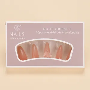 Detail of 30pcs almond-shaped press-on nails in nude pink with 3D heart embossments