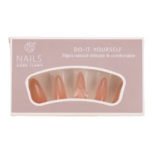 Set of 30pcs stiletto press-on nails in nude pink with rhinestone accents in a retail box