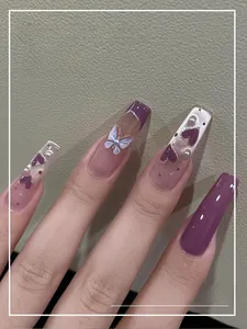 Macro view of long square press-on nails with purple cat-eye hearts and pearl details