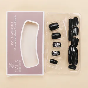 Detail of 30pcs black glitter press-on nails with silver butterflies in window box