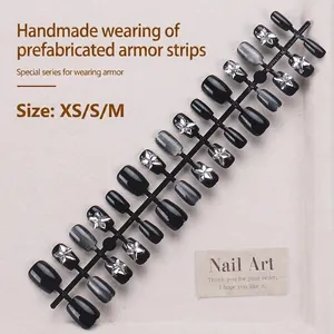 Short black glitter press-on nails with silver cat-eye stars and rhinestones set