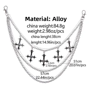 Detailed close-up of triple-layered metal hip chains with black enamel cross pendants
