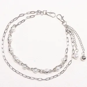 Detail of silver double-layered hip-hop pant chain with pearls and paperclip links