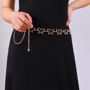 Golden hollow butterfly metal waist chain belt on black dress with adjustable chain