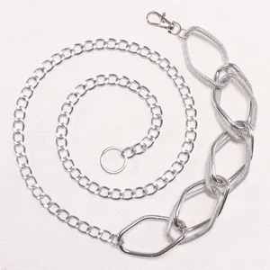 Macro detail of silver geometric waist chain with textured links and lobster clasp