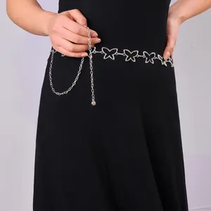 Detail of silver hollow butterfly metal waist chain on a black dress dress belt