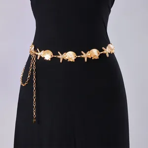 Bohemian gold metal waist chain featuring starfish and pearl shell charms on a black dress